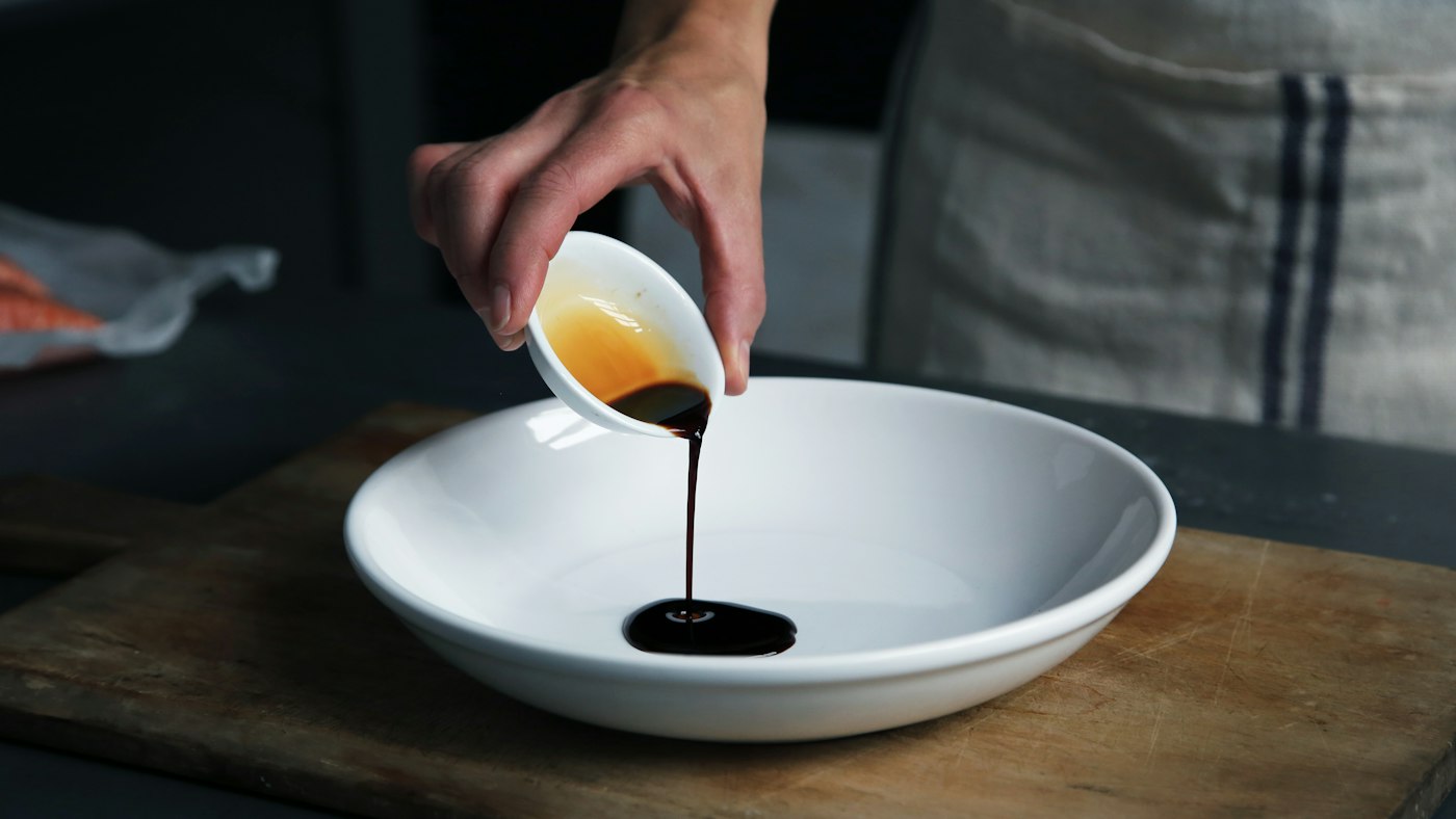 Traditional balsamic vinegar poured into a white bowl
