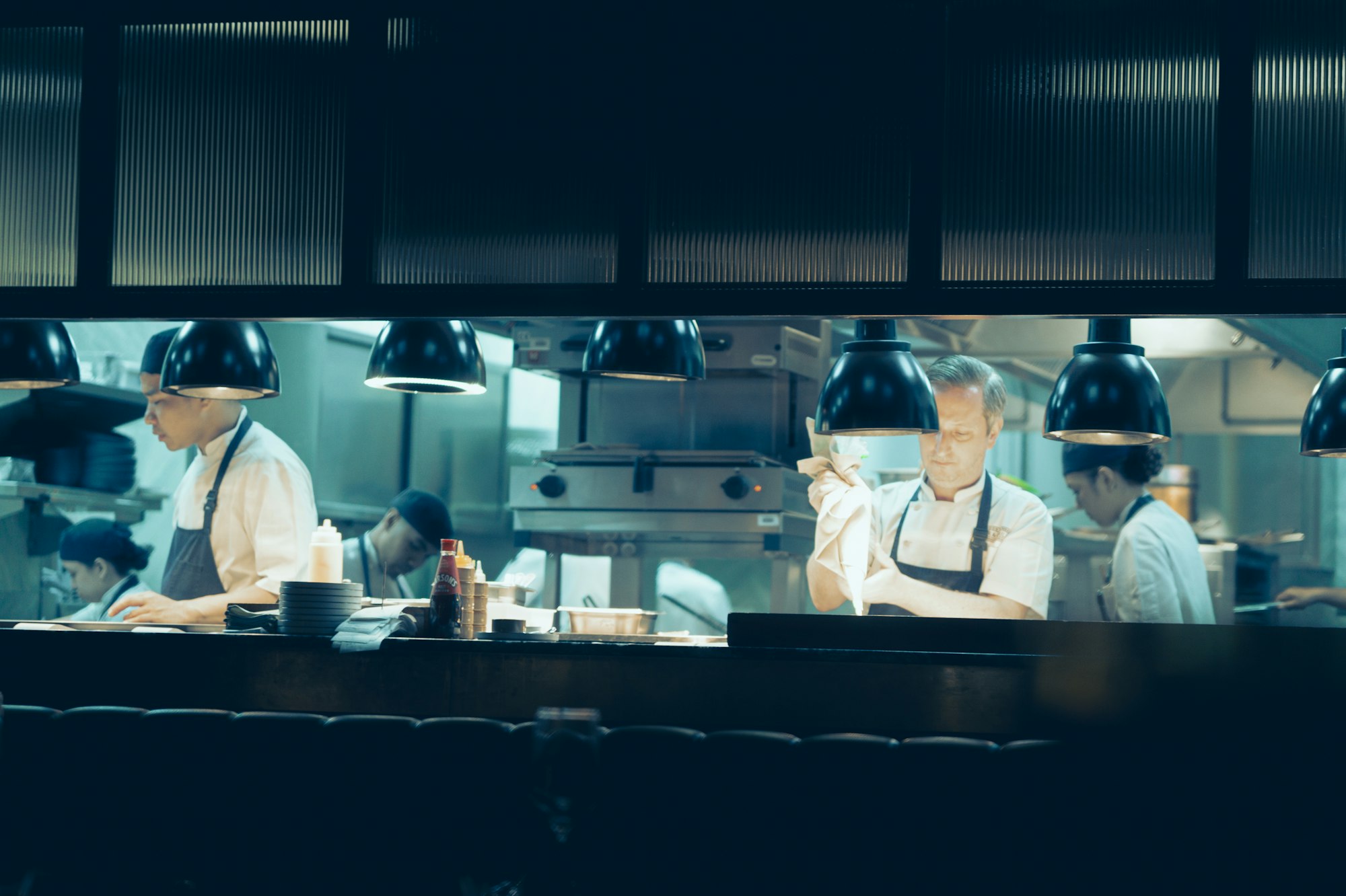 Chefs at work in a professional kitchen at night